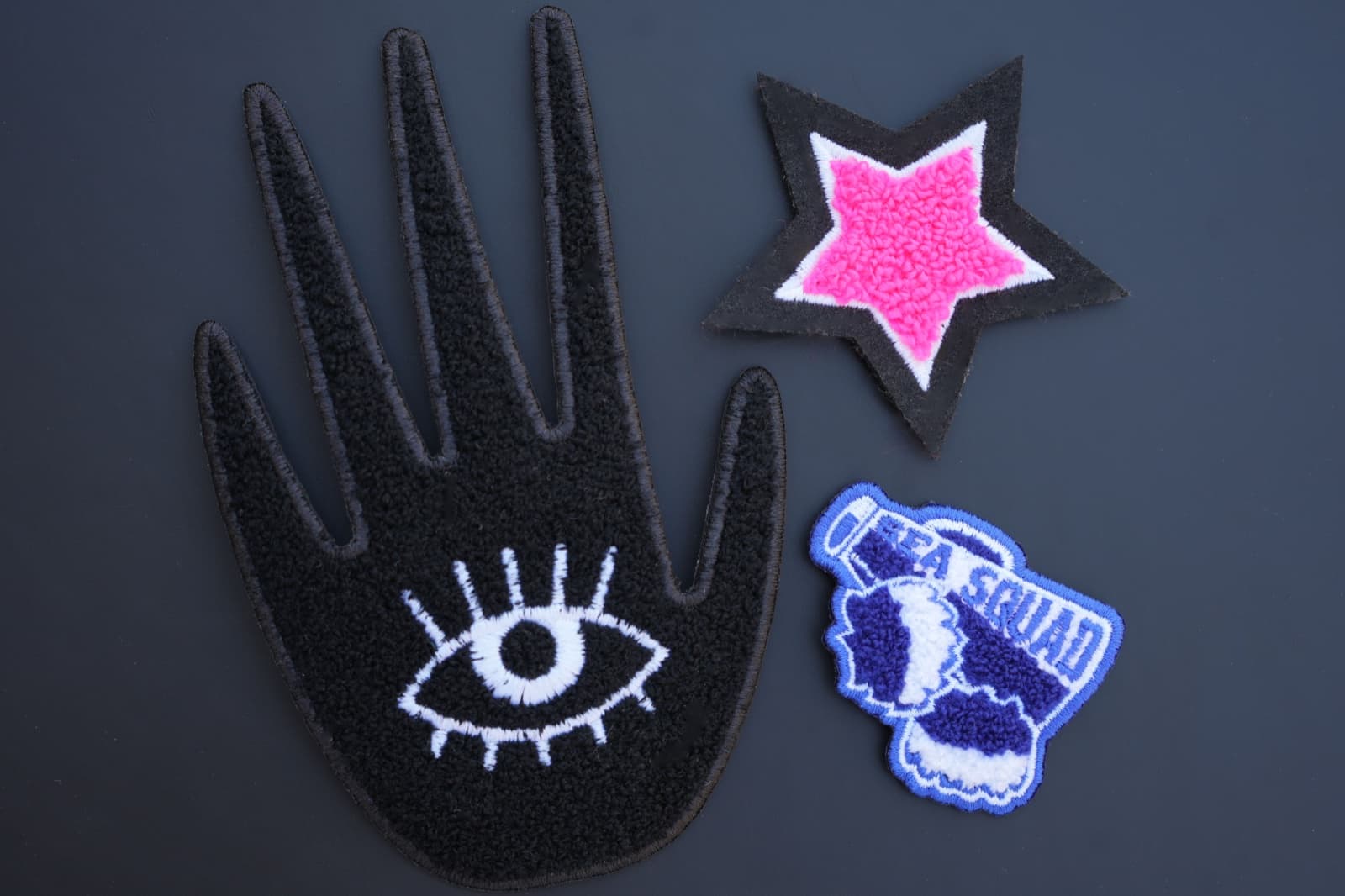 Chenille varsity-style patch showing fluffy tufted yarn texture on felt