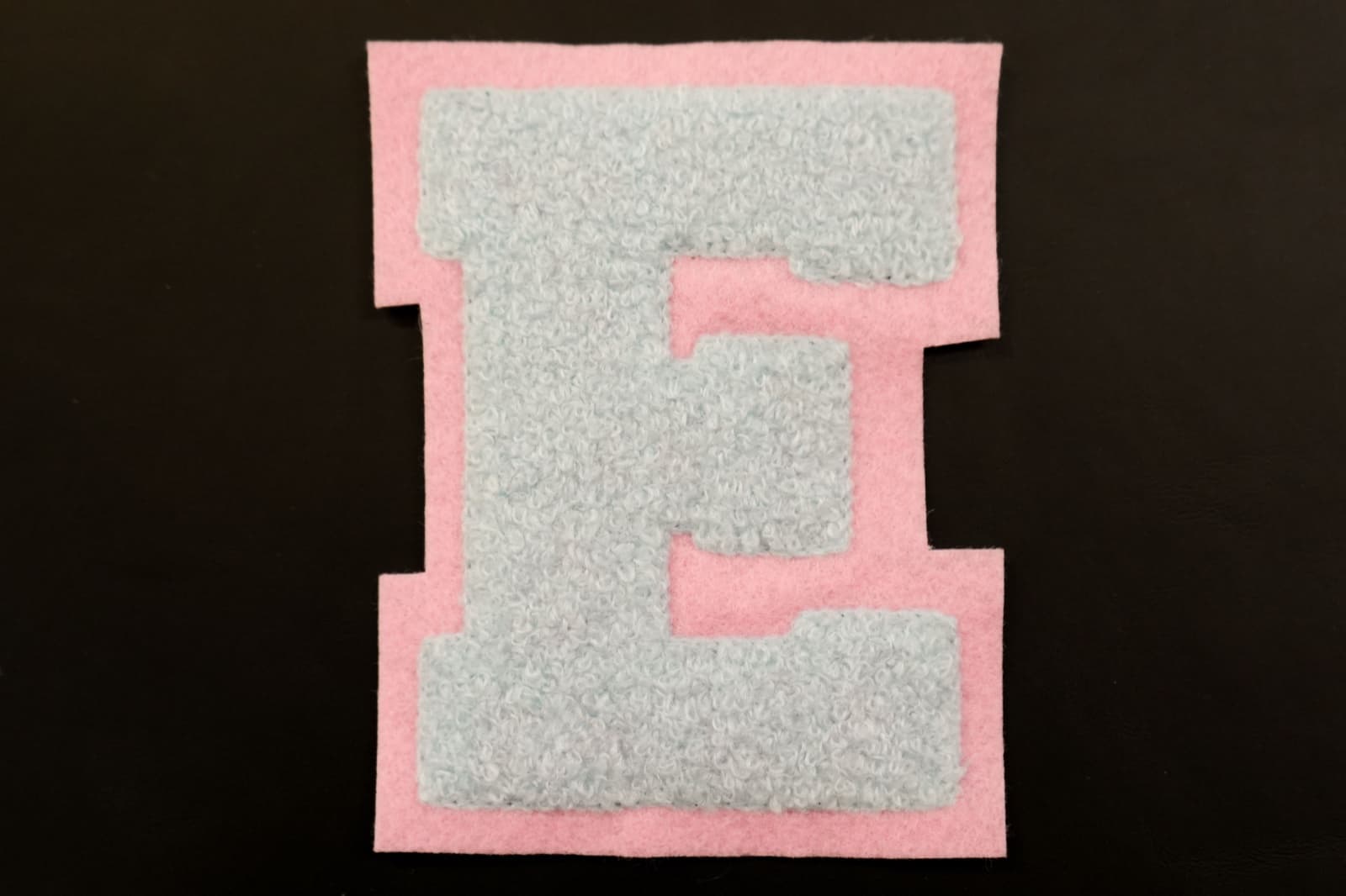 Classic chenille varsity letter patch showing fluffy tufted surface