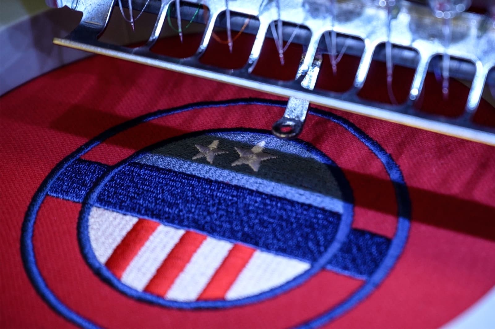 Commercial embroidery machine running a test stitch-out at the Digitizing.US facility