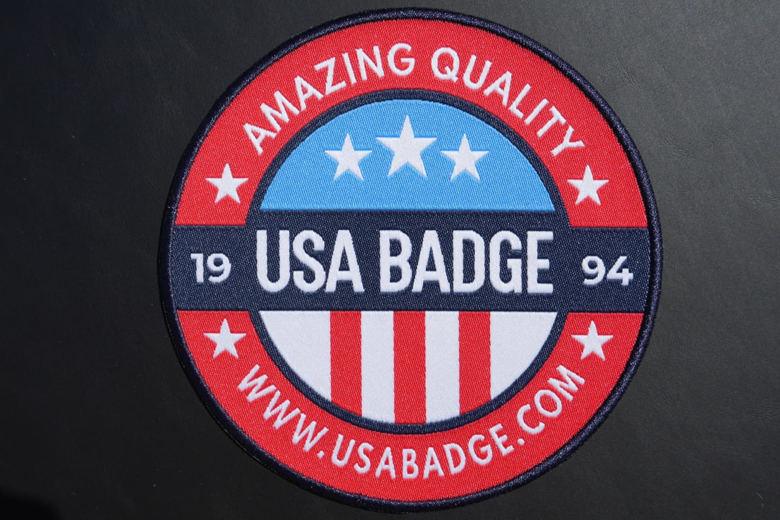 High thread count woven patch with fine detail and small readable text