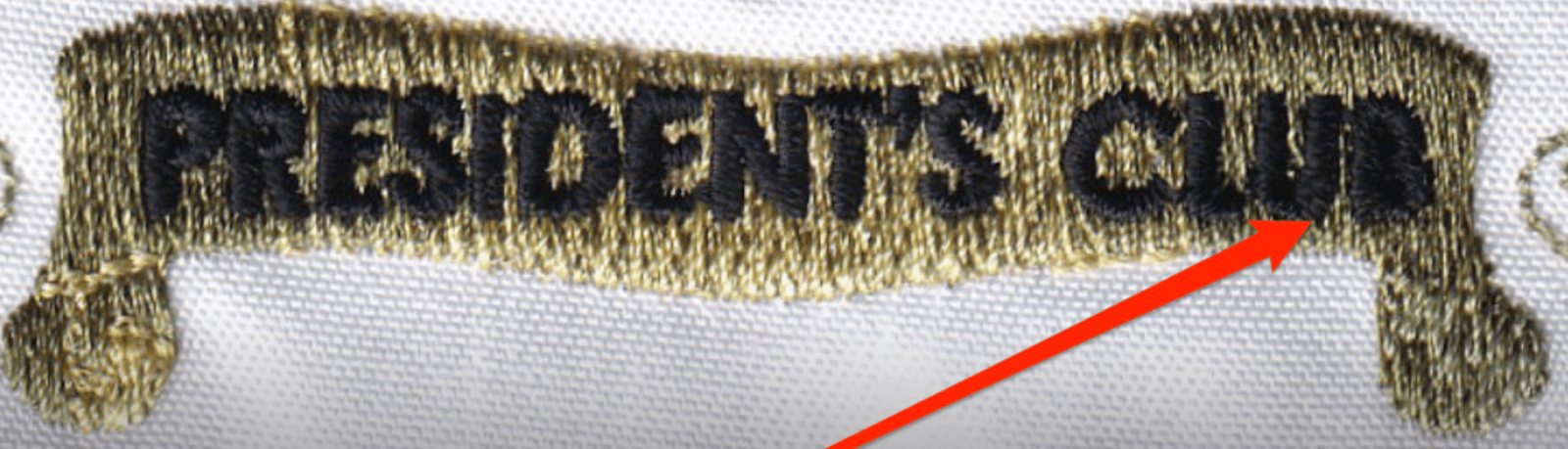 Small embroidered 'President's Club' text with the letters closed up โ the bowls filled with thread and the word reading as a smudge