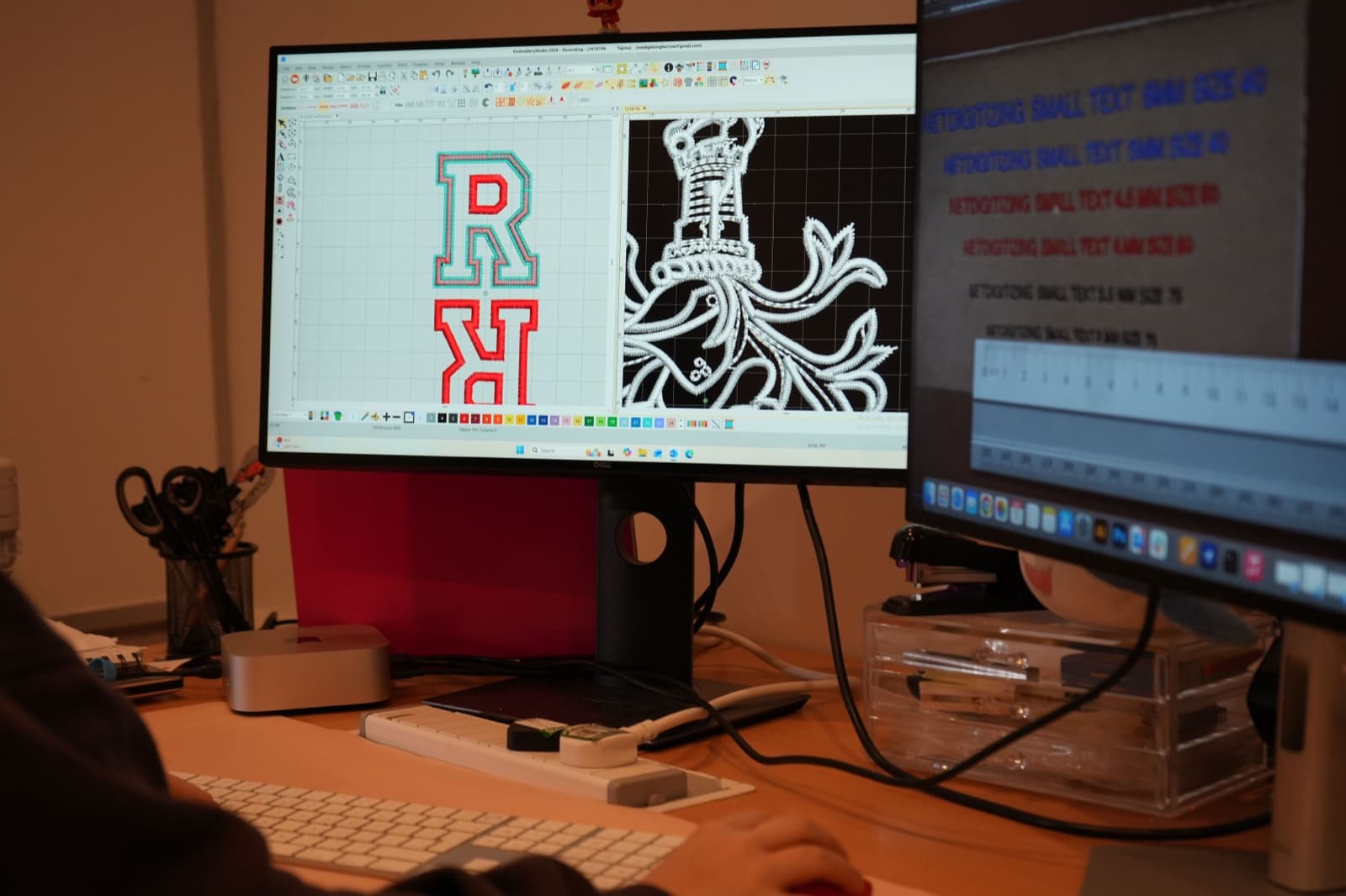 Digitizer working at dual-monitor Wilcom workstation with design in progress