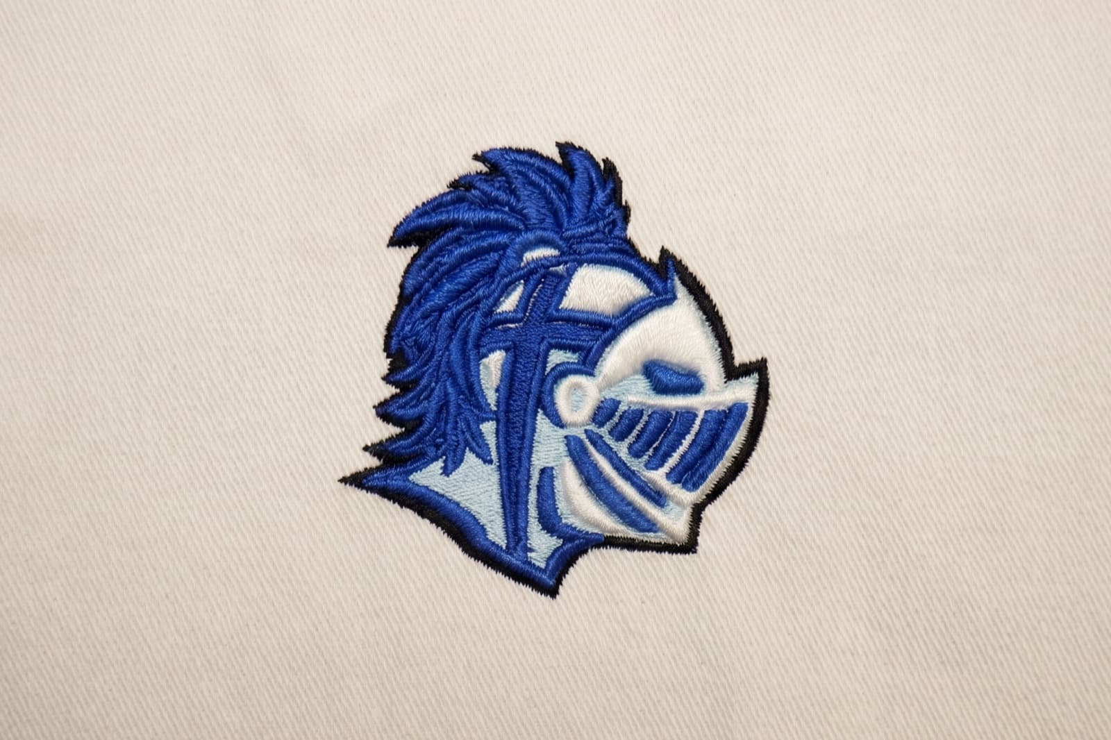 Clean well-digitized embroidery sew-out on polo fabric with crisp edges